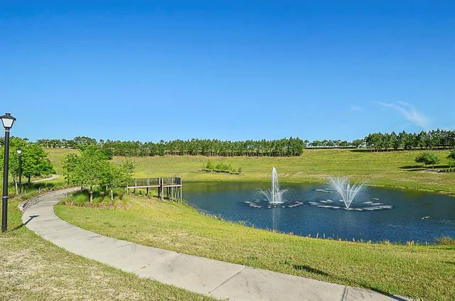 a view of a lake with a house in the background