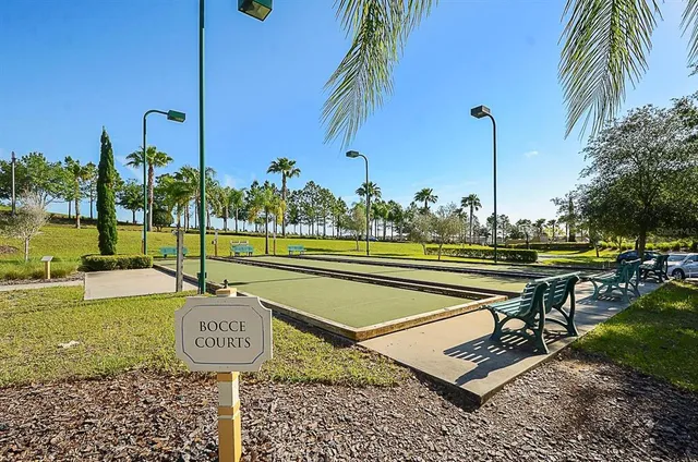 a view of a tennis court with a table and chairs