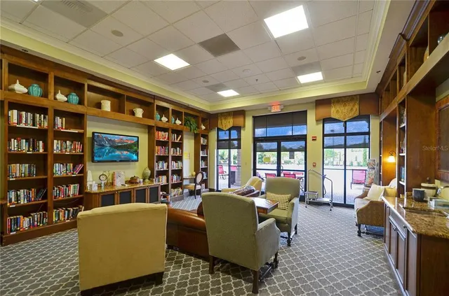 a living room with furniture and a bookshelf