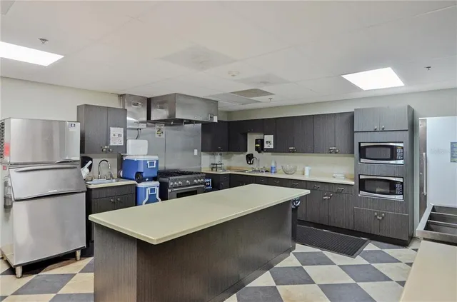 a kitchen with a refrigerator a stove a sink and a oven