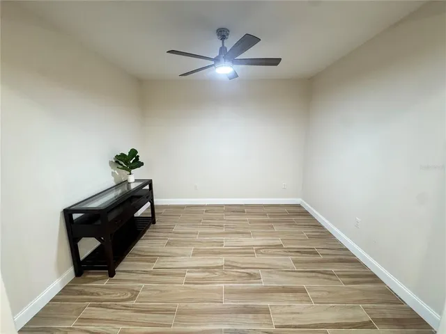 a bedroom with a bed and a potted plant