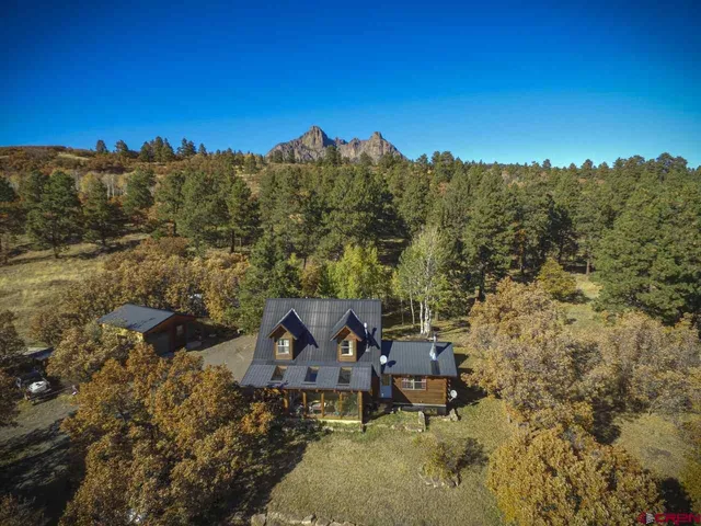 an aerial view of a house with mountain view