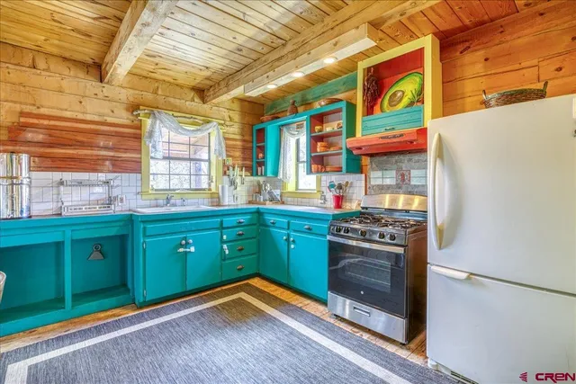 a kitchen with stainless steel appliances granite countertop a stove and a refrigerator