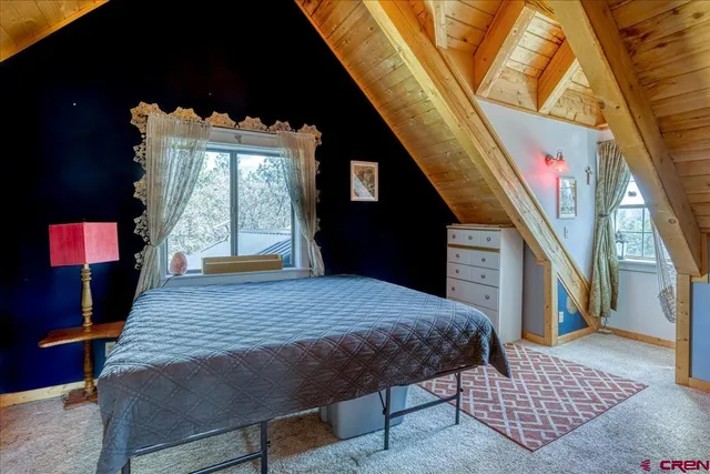 a bed sitting in a bedroom next to a window