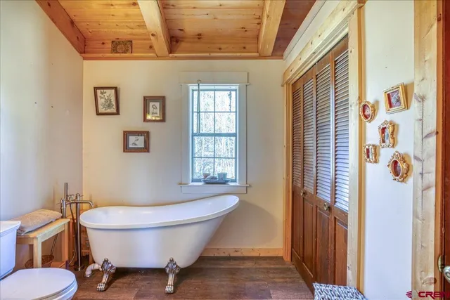 a bathroom with a toilet sink and window