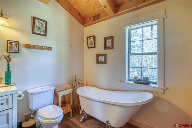 a bathroom with a toilet a sink and shower