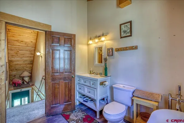 a living room with furniture and a baby crib