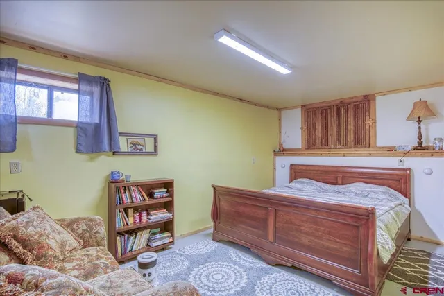 a view of a balcony with table and chairs and potted plants