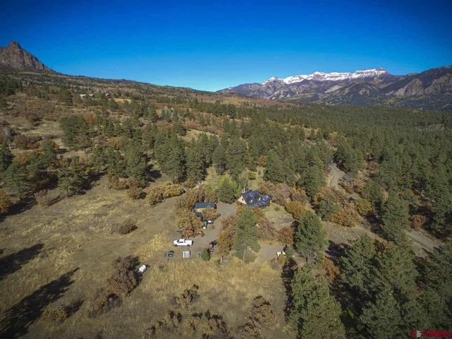 a view of a mountain range with a lush green hillside