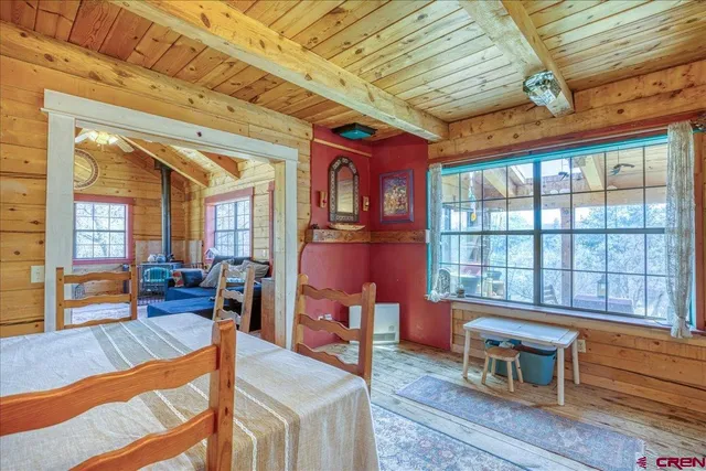 a living room with furniture a stove and a large window