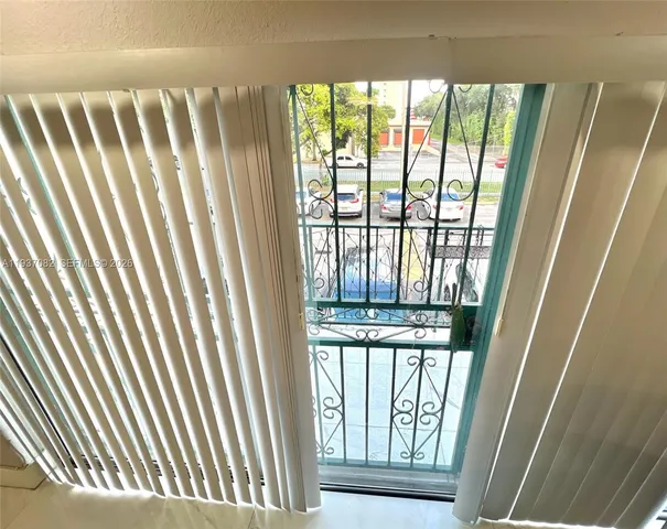 a kitchen with white cabinets and black appliances