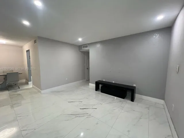 a kitchen with cabinets stainless steel appliances and a counter top space