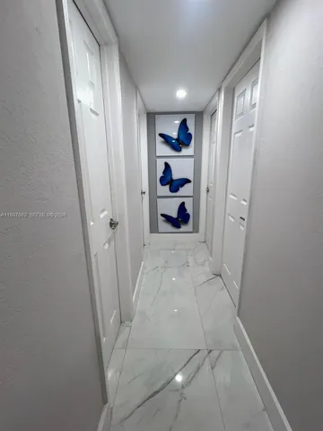 a view of a kitchen with white cabinets