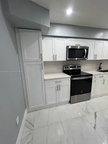 a kitchen with a stainless steel appliances and cabinets