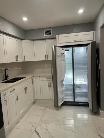 a kitchen with a cabinets and a stove top oven