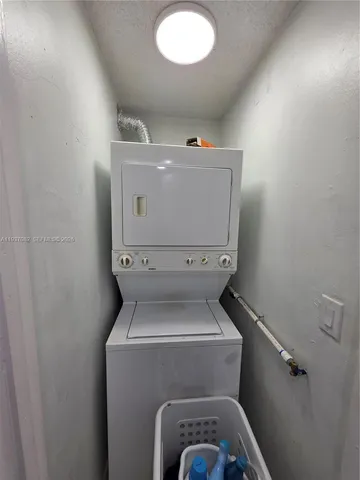 a bathroom with a granite countertop toilet sink and mirror