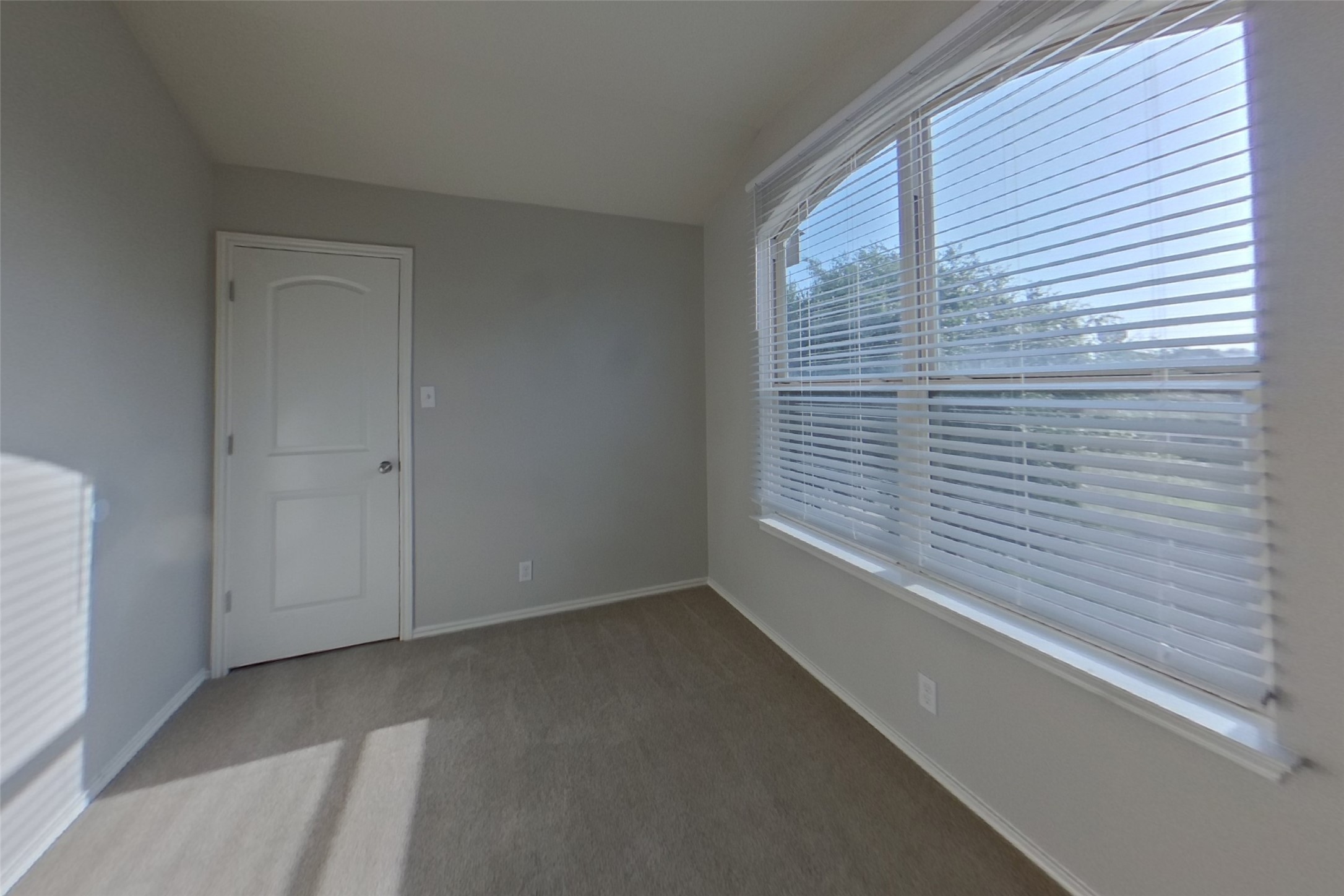 240 Dragon Ridge Road Buda, TX 78610 - Photo 17 of 20 A spacious window fills this carpeted secondary bedroom with abundant natural light.