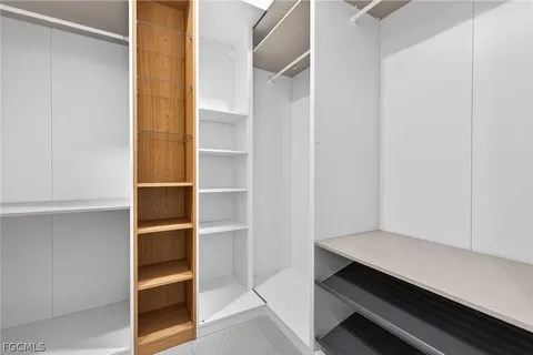 a room with walk in closet and empty racks