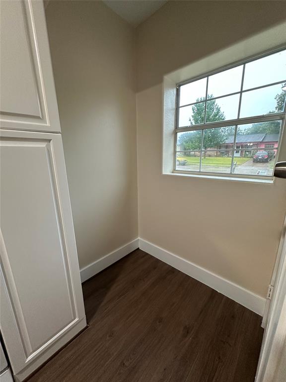 1609 Running River Road Garland, TX 75044 - Photo 14 of 37 an empty room with wooden floor and windows