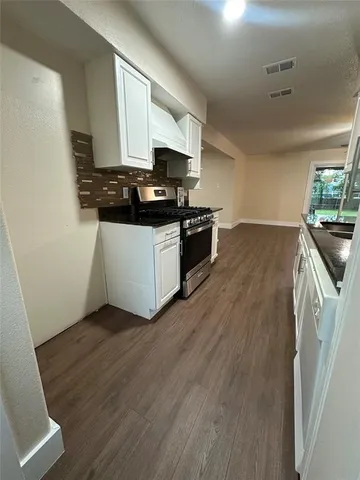 a kitchen with a sink and a stove top oven