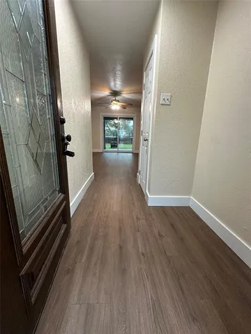 a view of a room with wooden floor