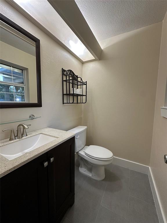 1609 Running River Road Garland, TX 75044 - Photo 34 of 37 a bathroom with a toilet sink and mirror