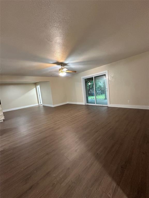 1609 Running River Road Garland, TX 75044 - Photo 6 of 37 a view of an empty room with wooden floor and a window