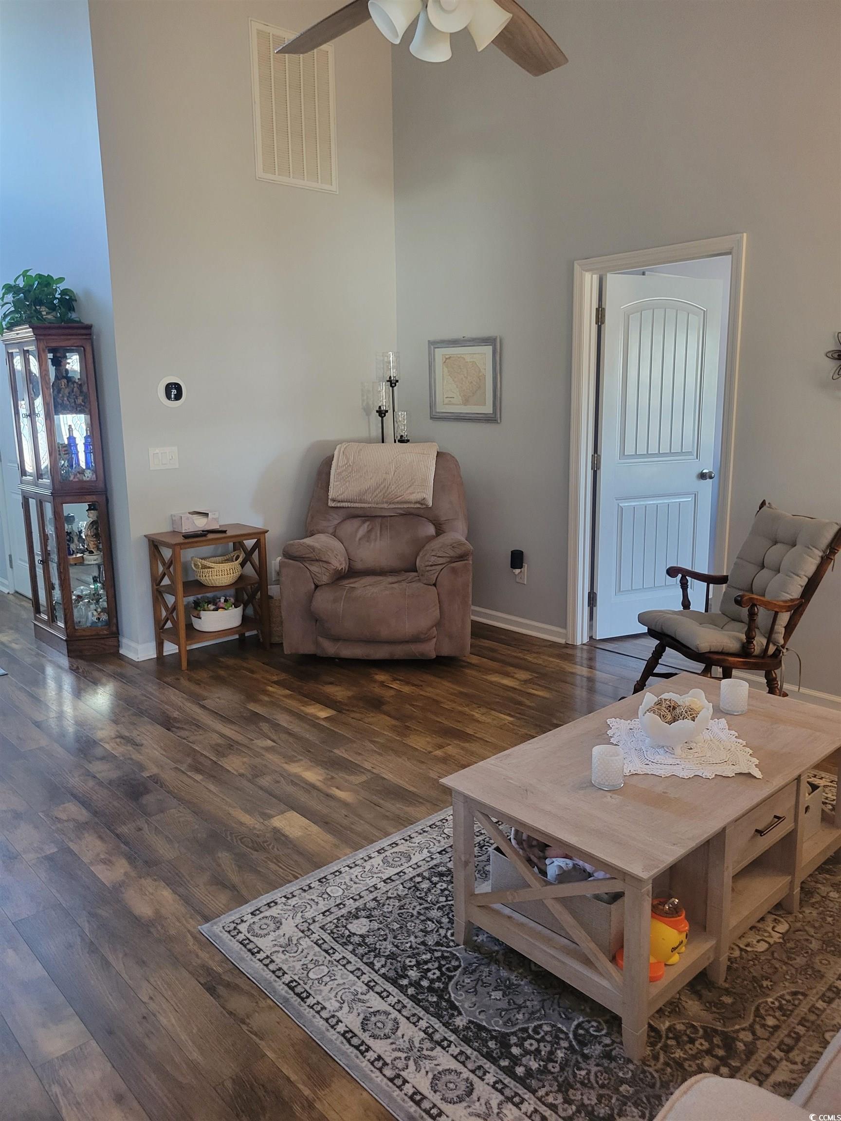 405 Beulah Circle Conway, SC 29527 - Photo 4 of 28 Living area featuring a towering ceiling, dark wood-style flooring, and a ceiling fan
