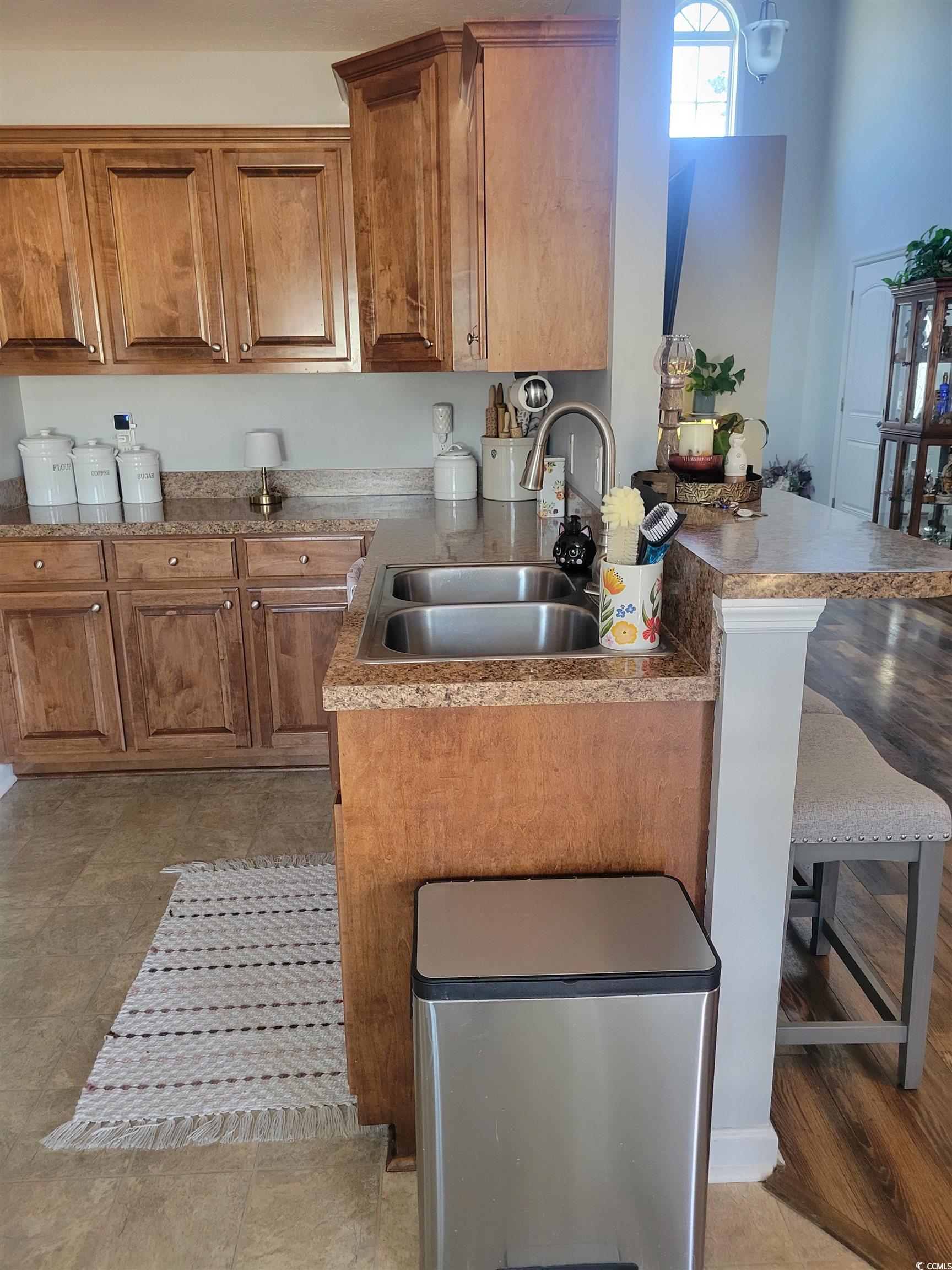 405 Beulah Circle Conway, SC 29527 - Photo 7 of 28 Kitchen featuring brown cabinets, a breakfast bar, a peninsula, and light countertops