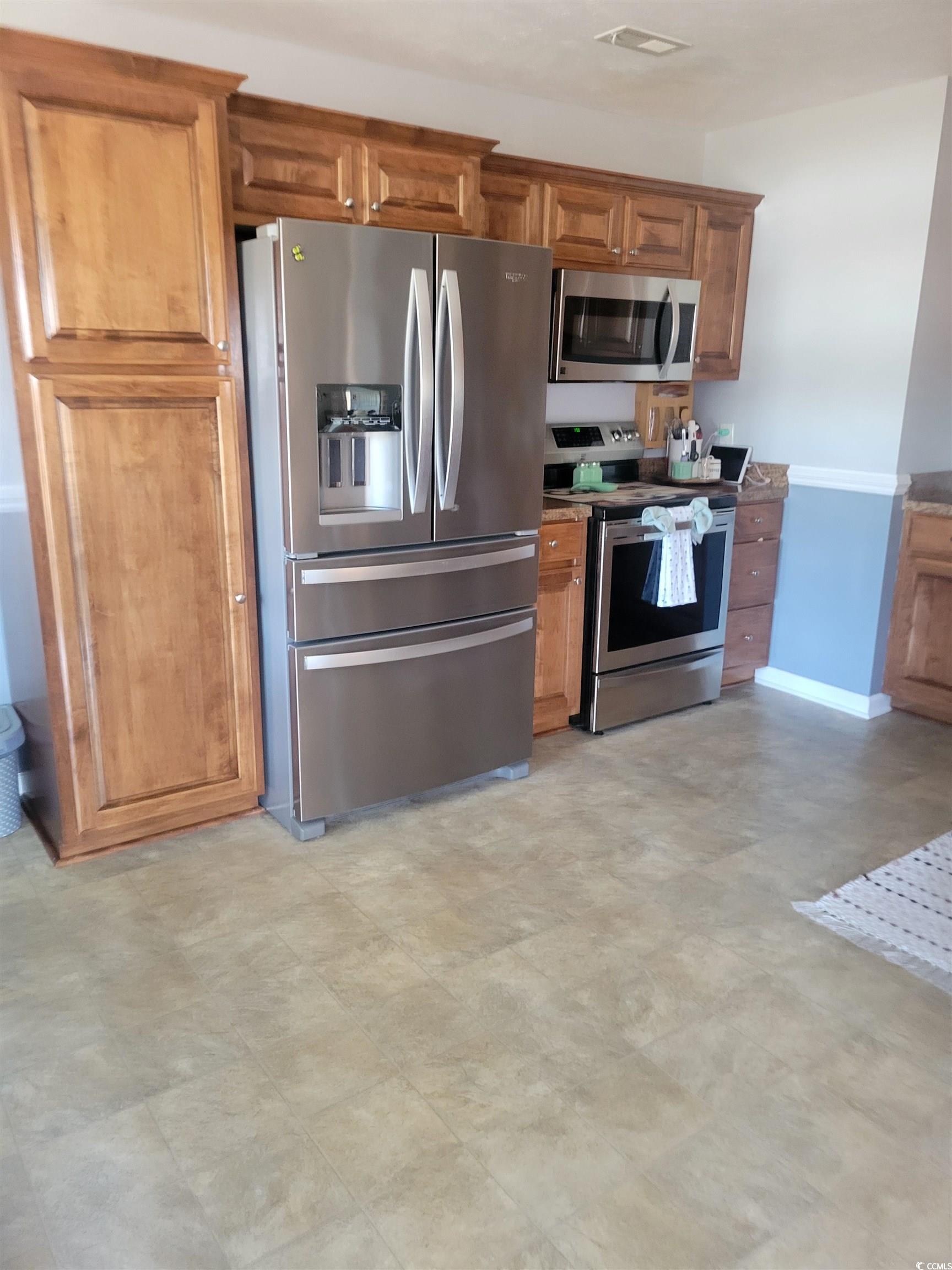 405 Beulah Circle Conway, SC 29527 - Photo 8 of 28 Kitchen featuring appliances with stainless steel finishes, brown cabinets, and light flooring