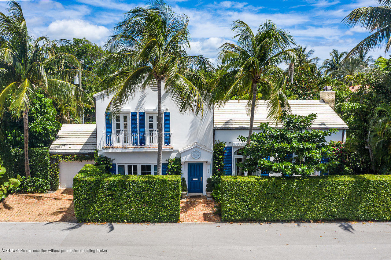 165 Root Trail Palm Beach, FL 33480 - Photo 1 of 39 a front view of a house with a garden