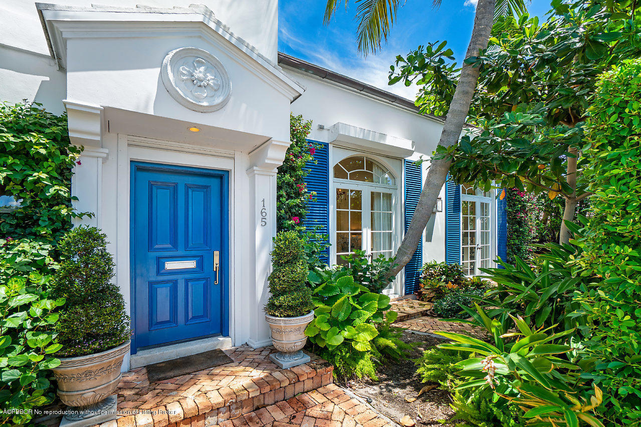 165 Root Trail Palm Beach, FL 33480 - Photo 2 of 39 a front view of a house with garden