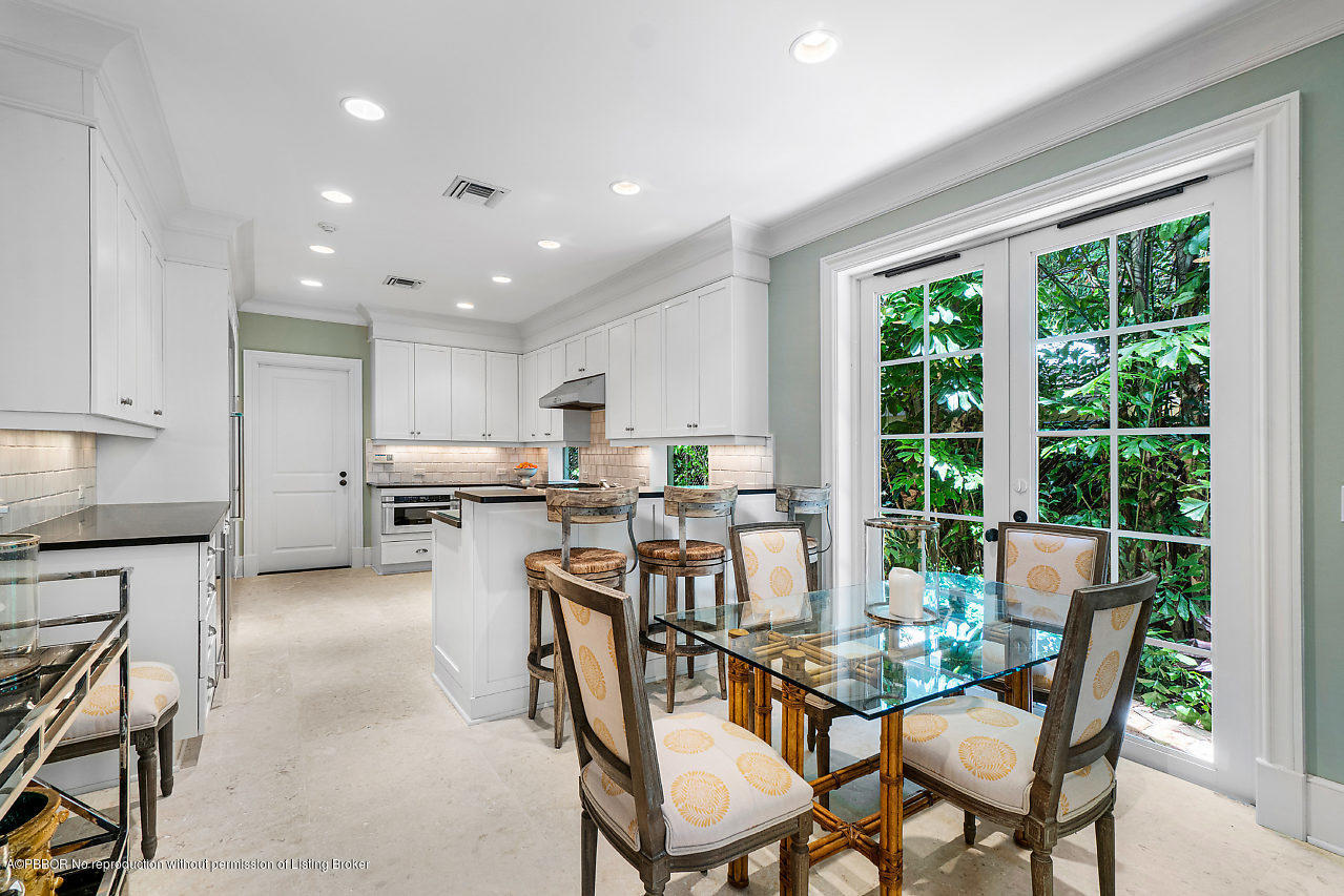 165 Root Trail Palm Beach, FL 33480 - Photo 11 of 39 a view of a dining room with furniture and a kitchen