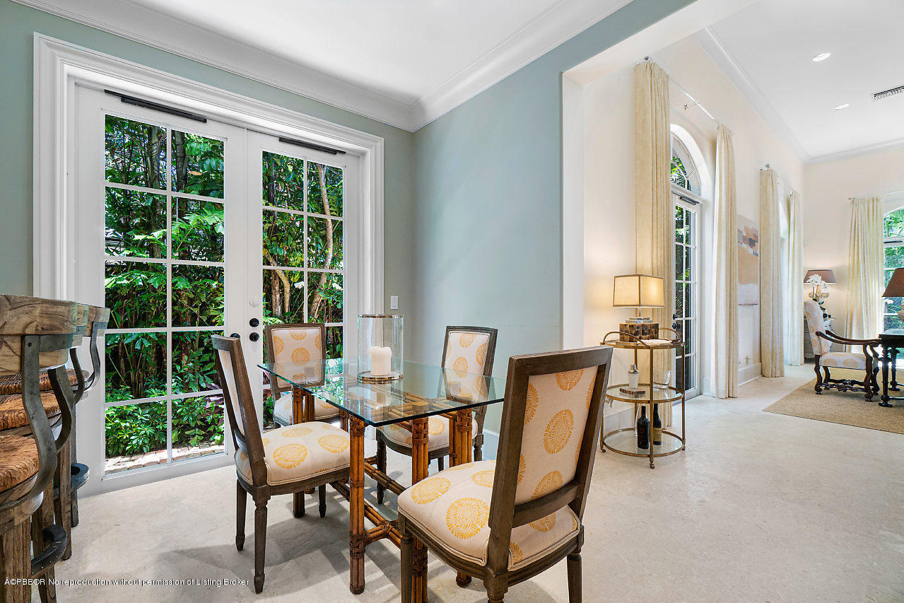 165 Root Trail Palm Beach, FL 33480 - Photo 12 of 39 a dining room with furniture and a floor to ceiling window