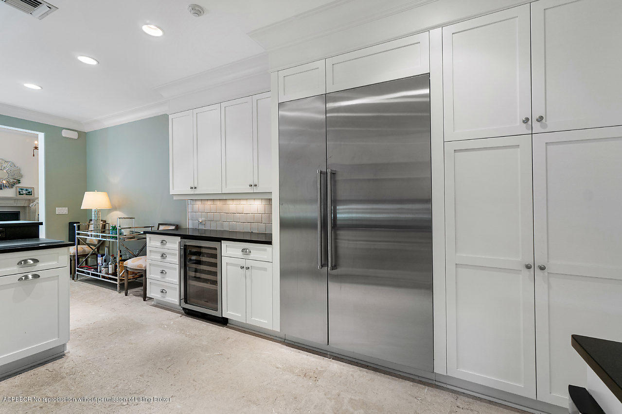 165 Root Trail Palm Beach, FL 33480 - Photo 15 of 39 a kitchen with a refrigerator and a stove top oven