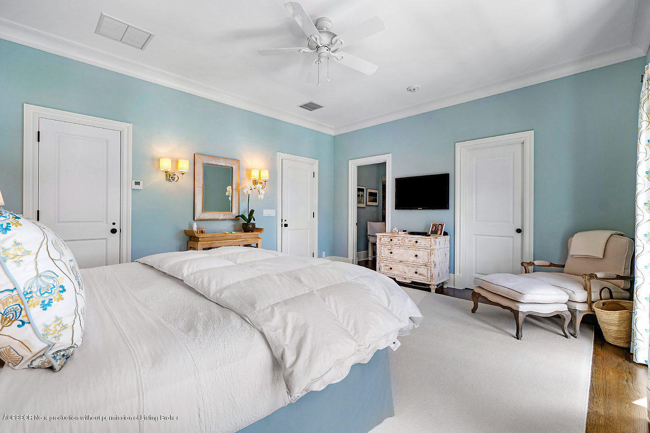 165 Root Trail Palm Beach, FL 33480 - Photo 20 of 39 a room with bed a couch and a flat screen tv