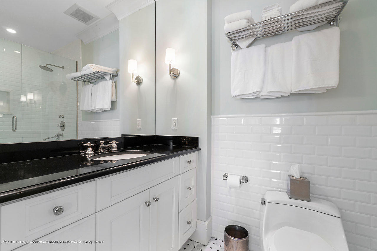 165 Root Trail Palm Beach, FL 33480 - Photo 21 of 39 a bathroom with a sink and a mirror