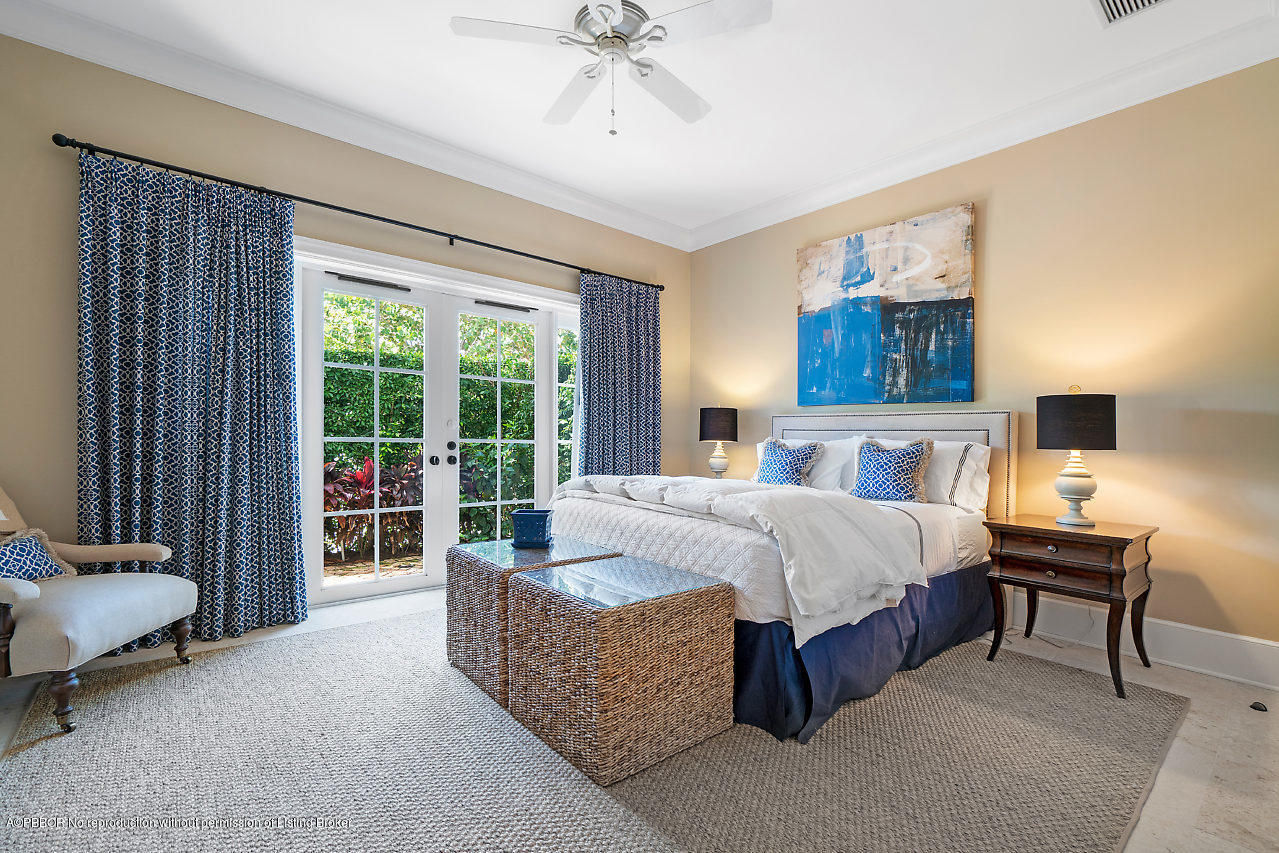 165 Root Trail Palm Beach, FL 33480 - Photo 25 of 39 a spacious bedroom with a bed and a couch