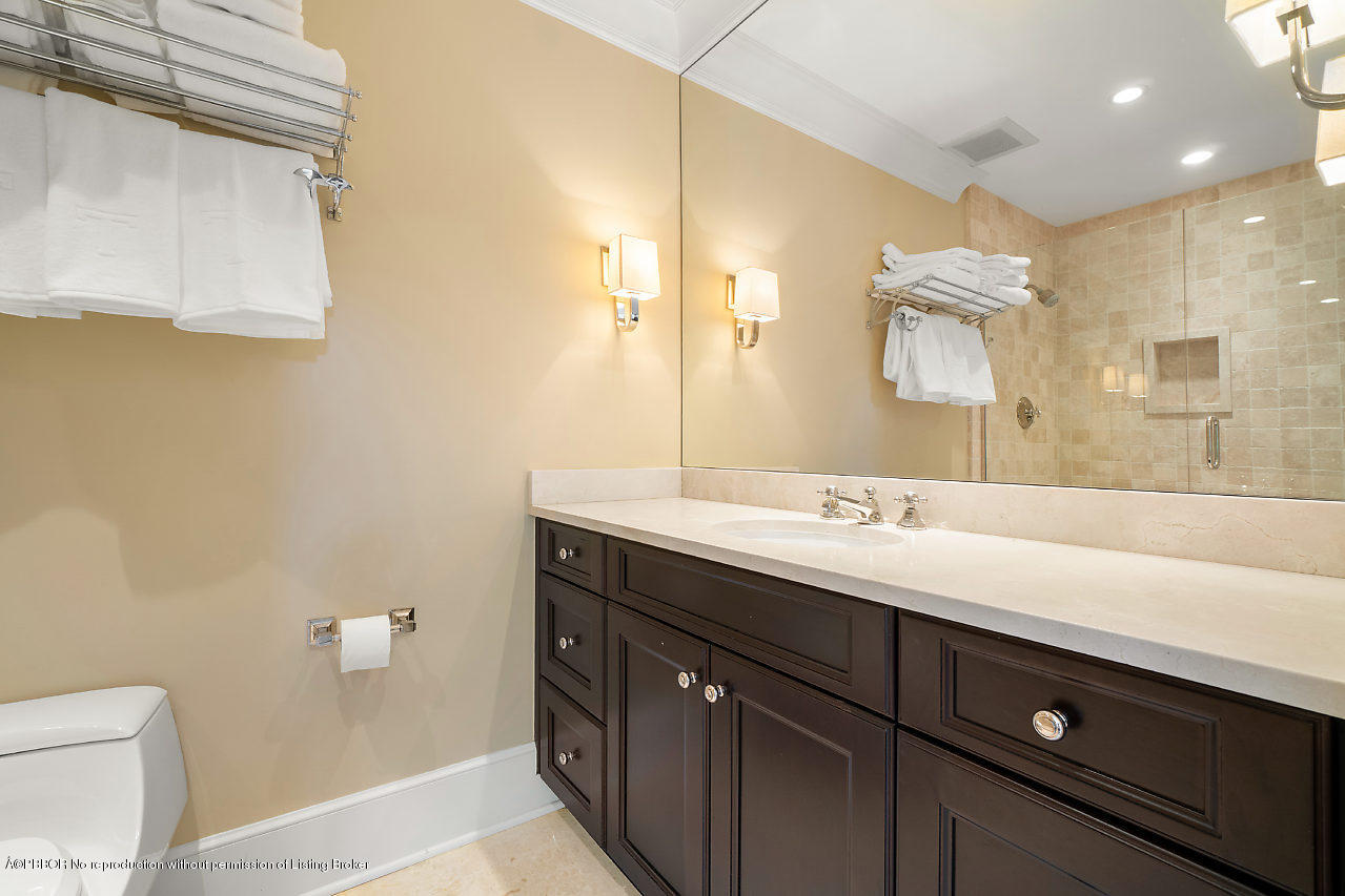 165 Root Trail Palm Beach, FL 33480 - Photo 26 of 39 a bathroom with a sink a toilet and a mirror