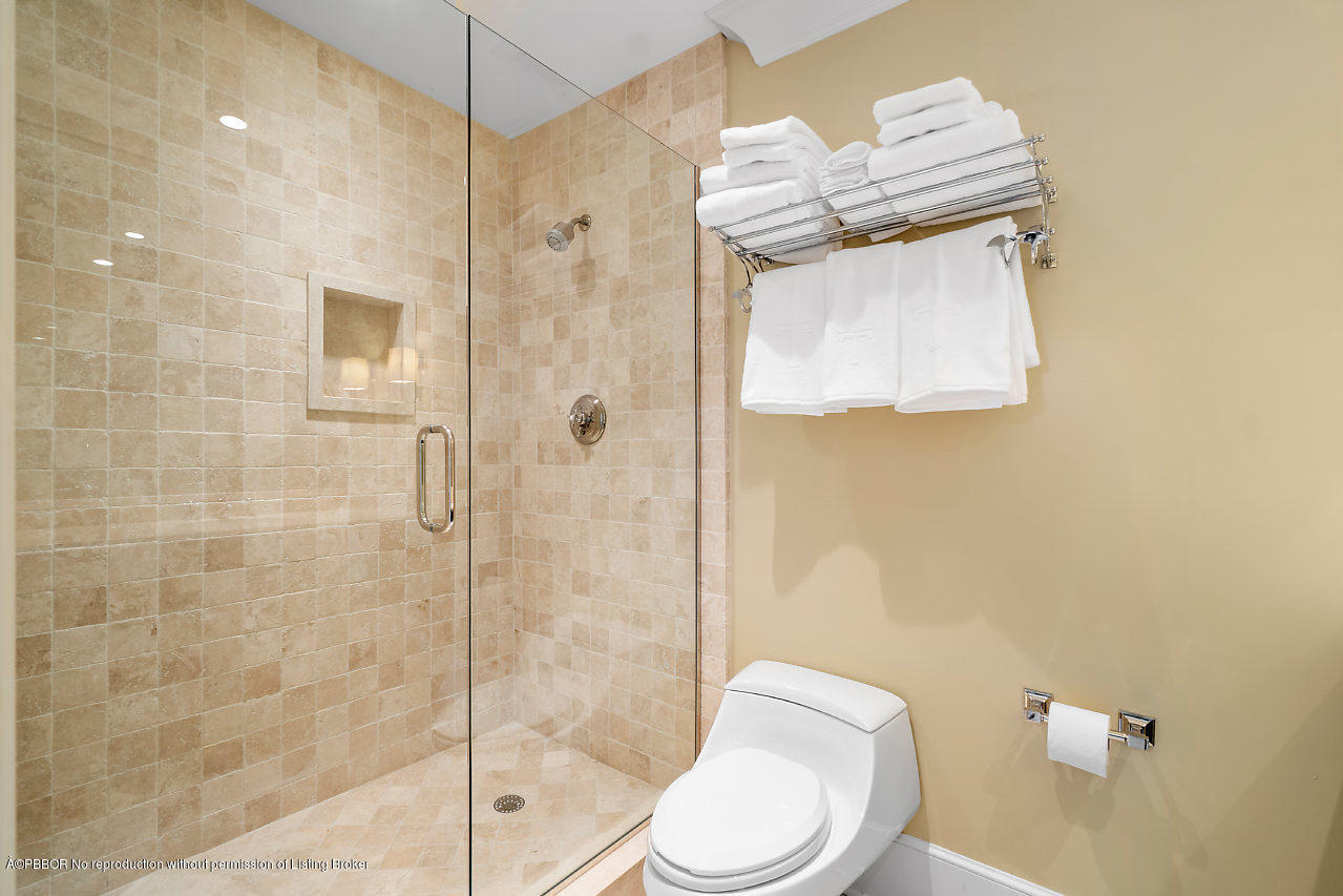 165 Root Trail Palm Beach, FL 33480 - Photo 27 of 39 a white toilet sitting next to a bathroom shower