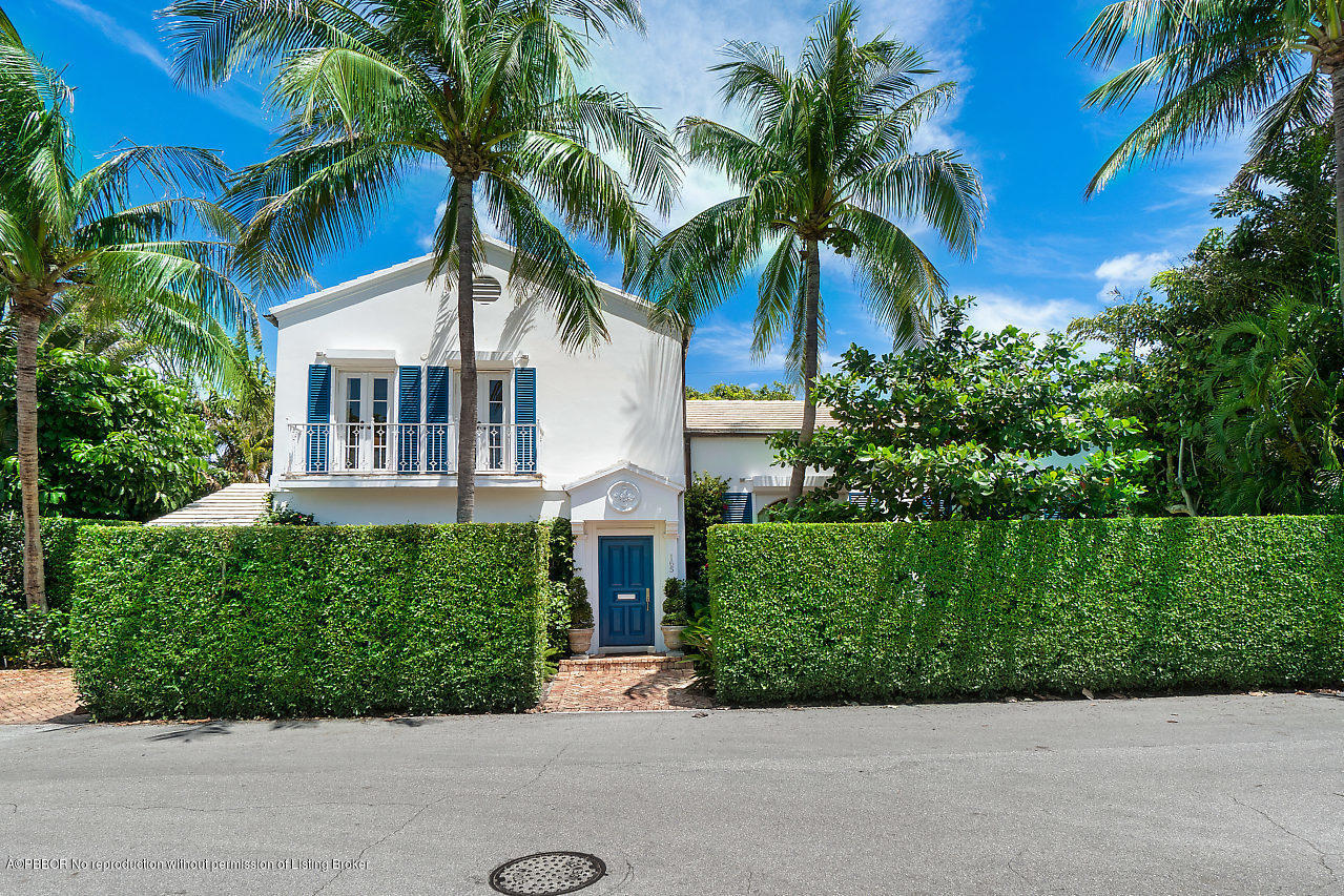 165 Root Trail Palm Beach, FL 33480 - Photo 33 of 39 a front view of a house with a yard and garage