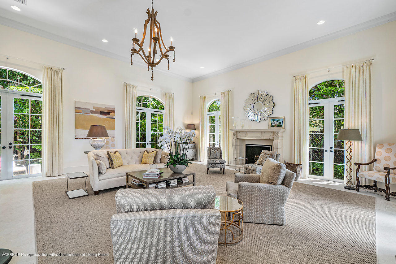 165 Root Trail Palm Beach, FL 33480 - Photo 6 of 39 a living room with furniture a fireplace and a chandelier
