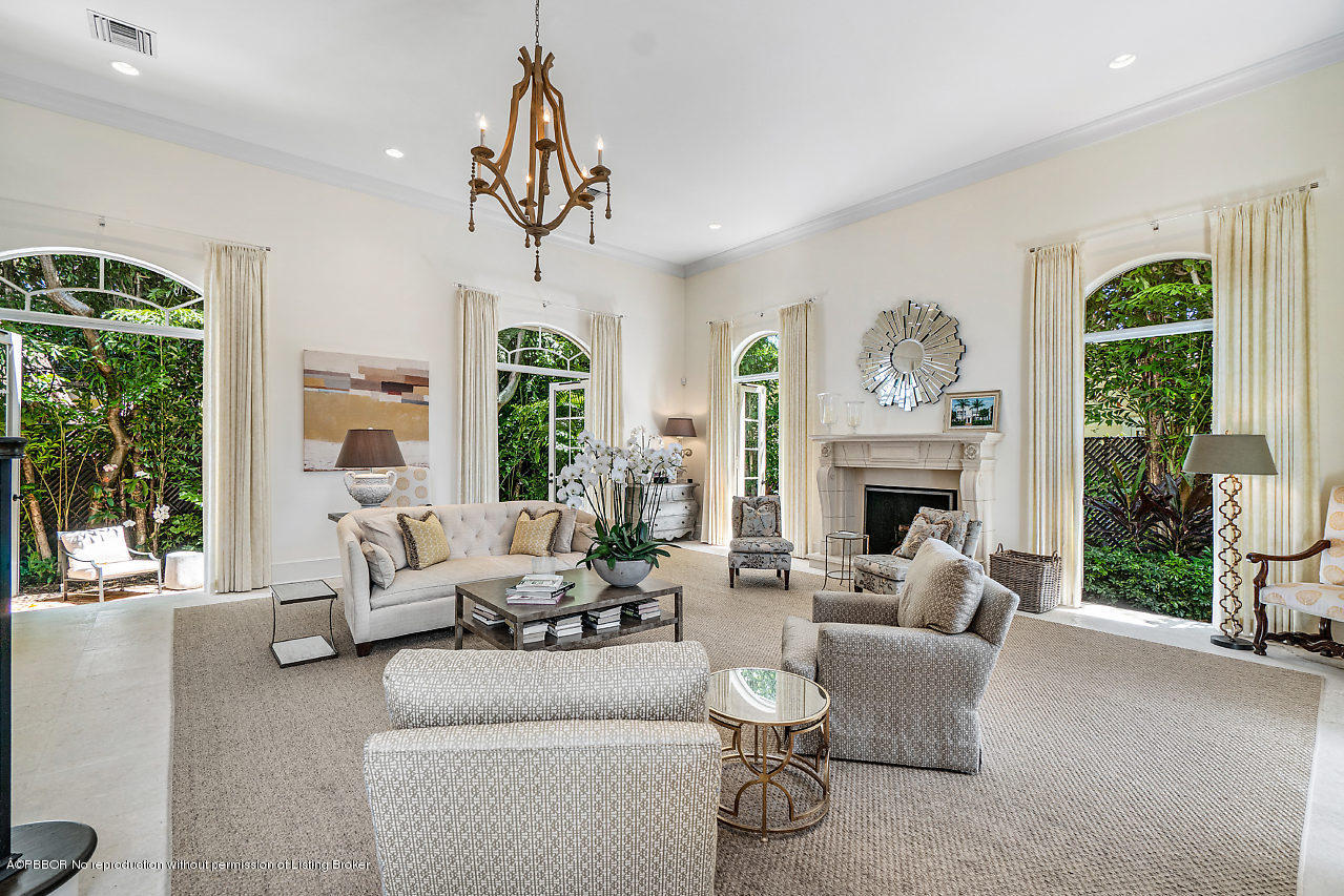 165 Root Trail Palm Beach, FL 33480 - Photo 10 of 39 a living room with furniture a fireplace and a large window