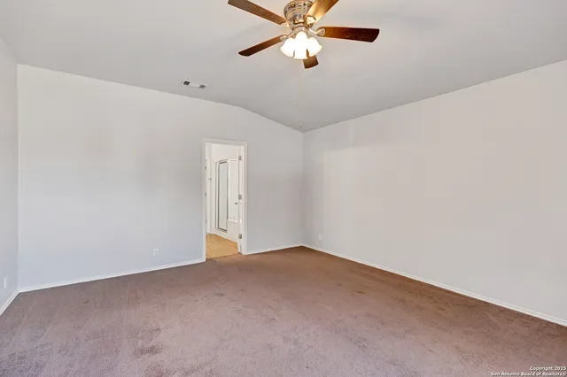 a spacious bathroom with a granite countertop sink a mirror and a bathtub