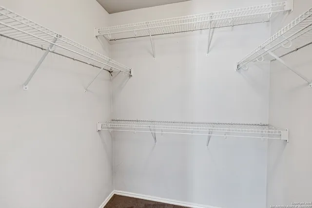 a bathroom with a granite countertop toilet and a sink