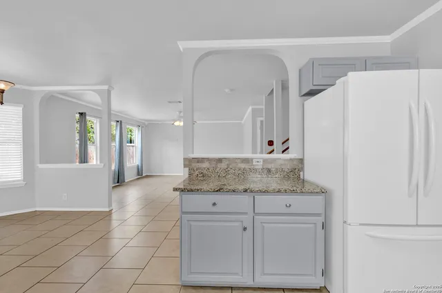 a bathroom with a granite countertop sink a mirror and a shower