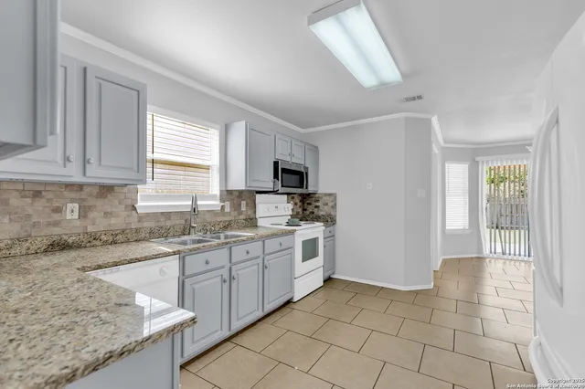 a kitchen with a sink cabinets and window