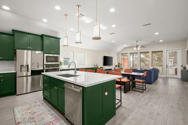 a large kitchen with stainless steel appliances lots of counter space