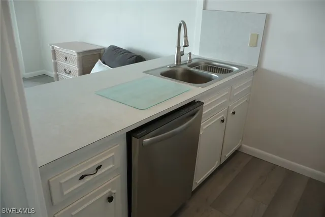 a kitchen with a sink and a refrigerator