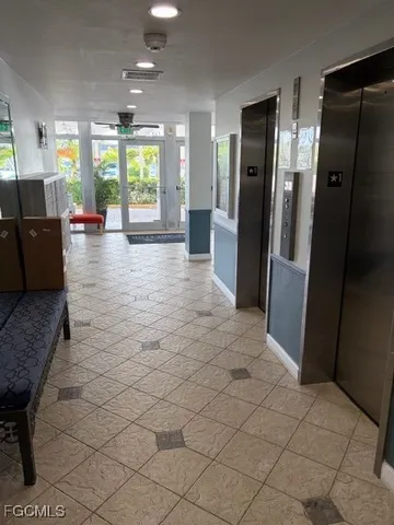 a view of a refrigerator in kitchen and an empty room